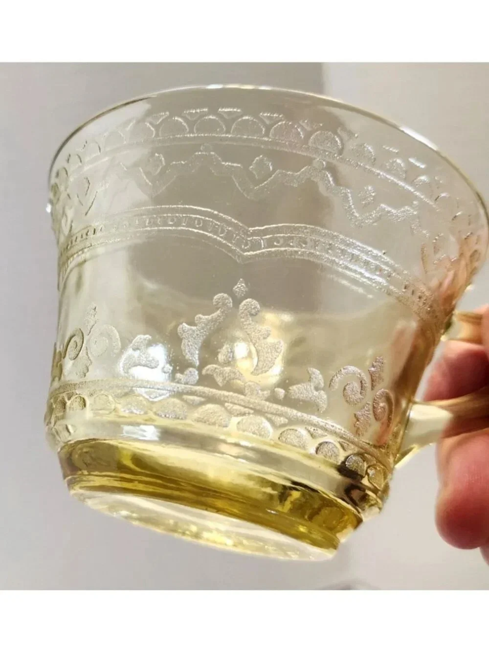 Elegant Amber Glass Teacup with Etched Decorative Pattern